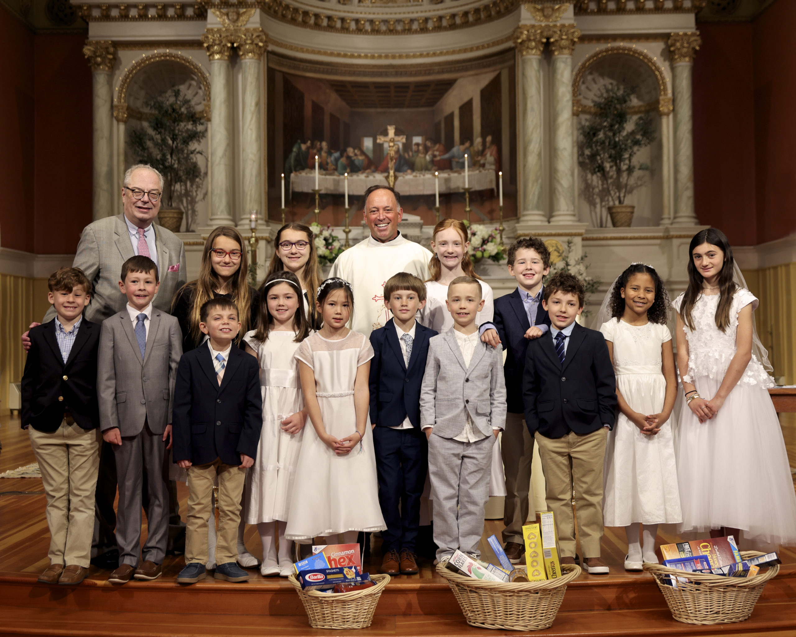 Father John with our 2022 First Communion class, photo by Cheryl Richards
